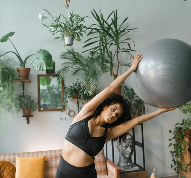 black woman doing exercises with a ball