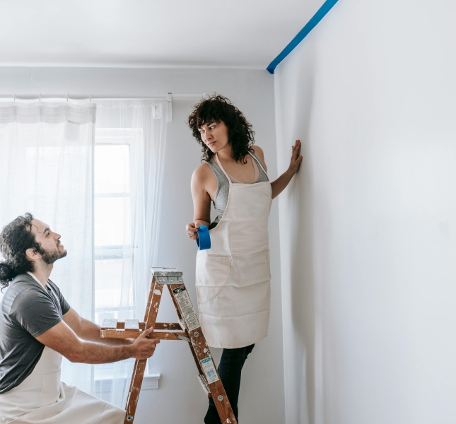 man and woman painting the wall