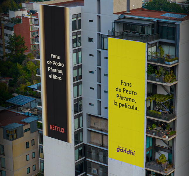 The image features two large billboards on buildings, one advertising a book titled "Pedro Páramo" associated with Netflix, and the other promoting the film adaptation of the same title.