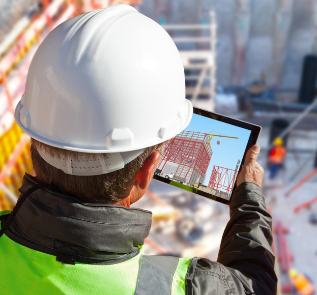 A construction worker looking at a tablet