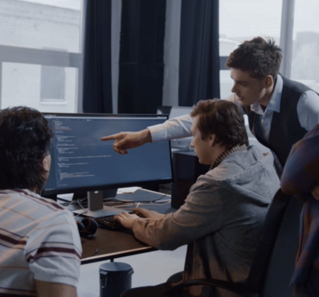 Employees working together around a desk