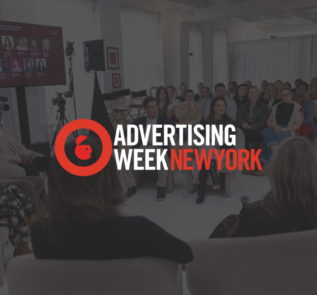 A panel discussion in progress at an event, with the "Advertising Week New York" logo overlaid in the center. In the background, a group of panelists sits in a semi-circle of chairs facing an audience, with a large screen displaying speaker headshots on the wall.