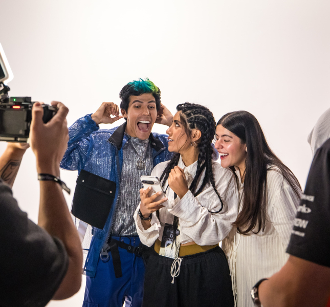 Experiential marketing event attendees are filmed interacting with a Google device, highlighting the creation of multi-modal content (video, social media, case study image) for a brand activation strategy.