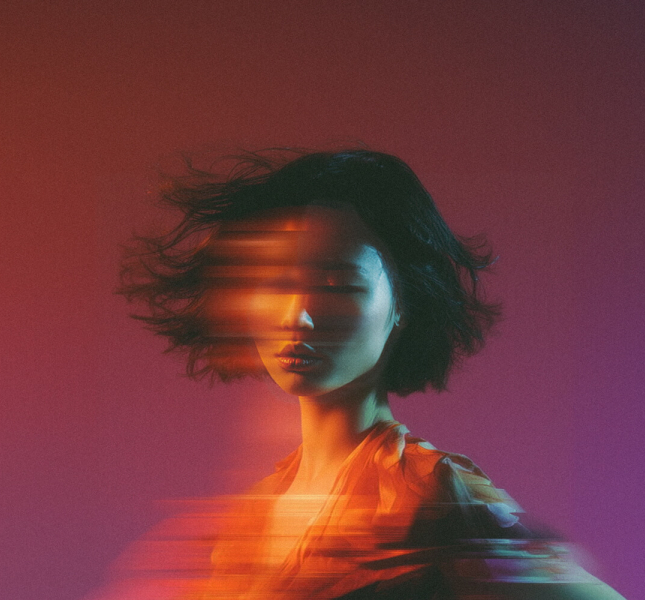 woman with digital effect that makes it look like a long exposure photo where she is moving horizontally
