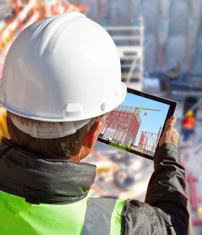 A construction worker looking at a tablet