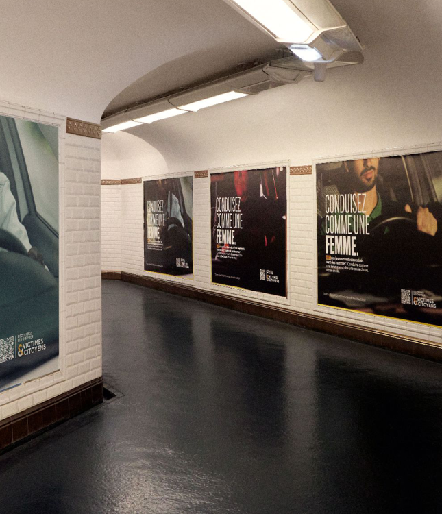 The image depicts an underground passage lined with posters promoting safe driving, using the slogan "CONDUISEZ COMME UNE FEMME," while statistics indicate that 84% of road fatalities involve men.