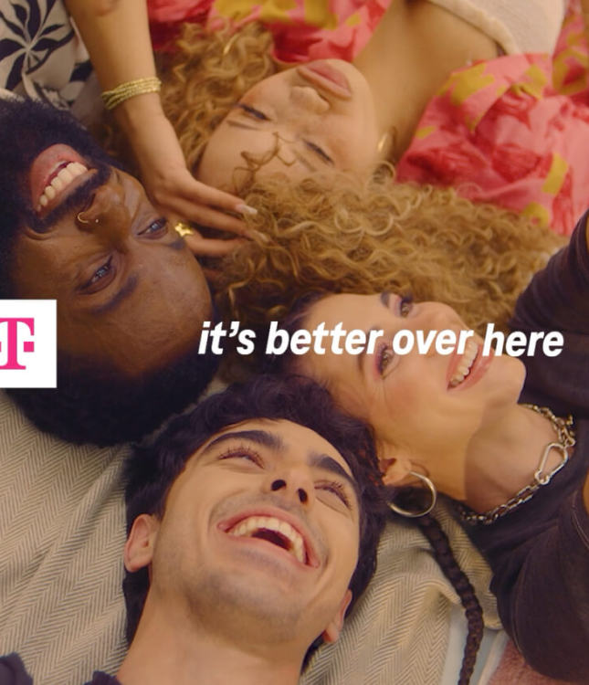 A group of T-Mobile users laying together on a picnic blanket with the words "it's better over here" over the image.