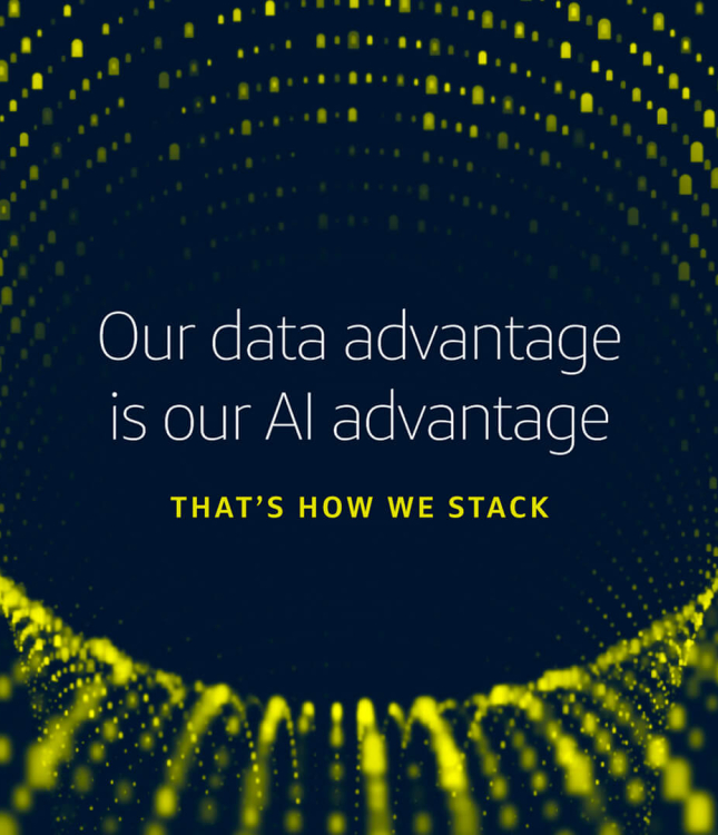 A digital graphic with a dark blue background featuring a swirling, three-dimensional tunnel made of small, glowing yellow dots. The Capital One logo is in the top left corner. Centered on the screen is white text that reads, "Our data advantage is our AI advantage," followed by smaller yellow text underneath saying, "THAT'S HOW WE STACK."