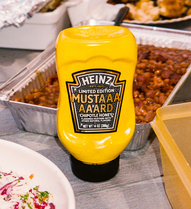 Close-up detail shot of the Limited Edition Heinz MUSTAAAARD Chipotle Honey 14oz bottle, emphasizing the unique flavor name and packaging for a product description page.
