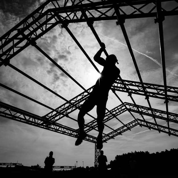 A person doing crossfit climbing a rope