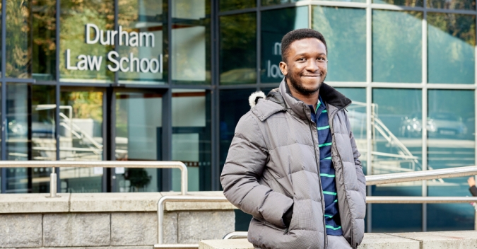 A man standing in front of a school