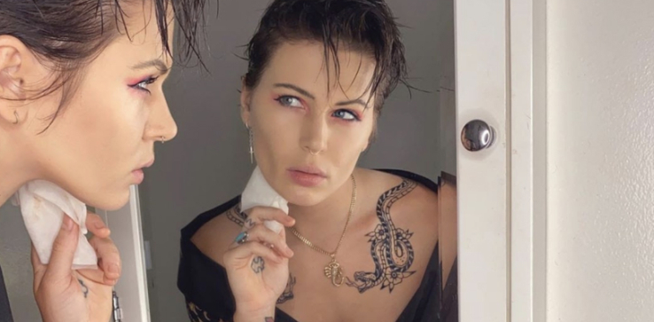 A person applying make up to their face in a mirror