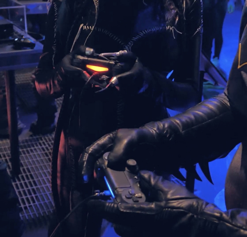 Batman characters playing with video controllers in the Batman Experience