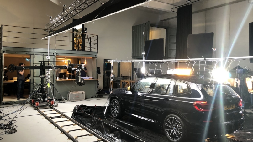 A studio with film equipment shooting a suv commercial