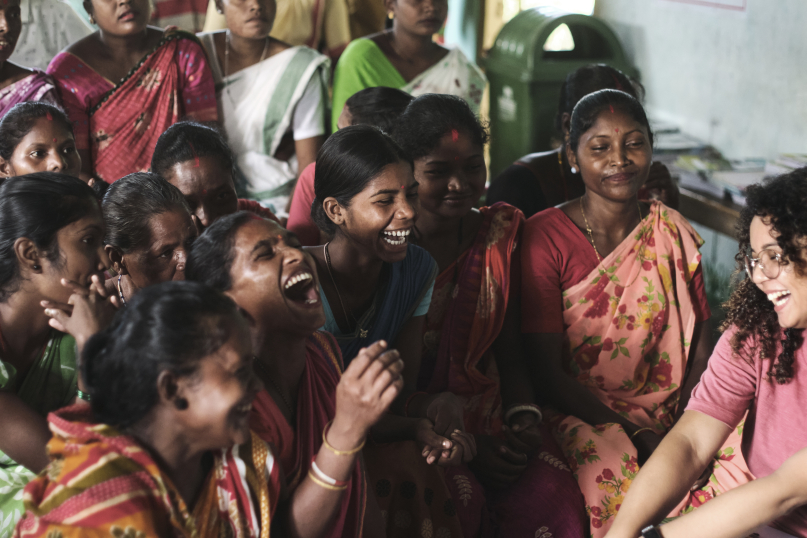 A group of Indian women laughing with each other.