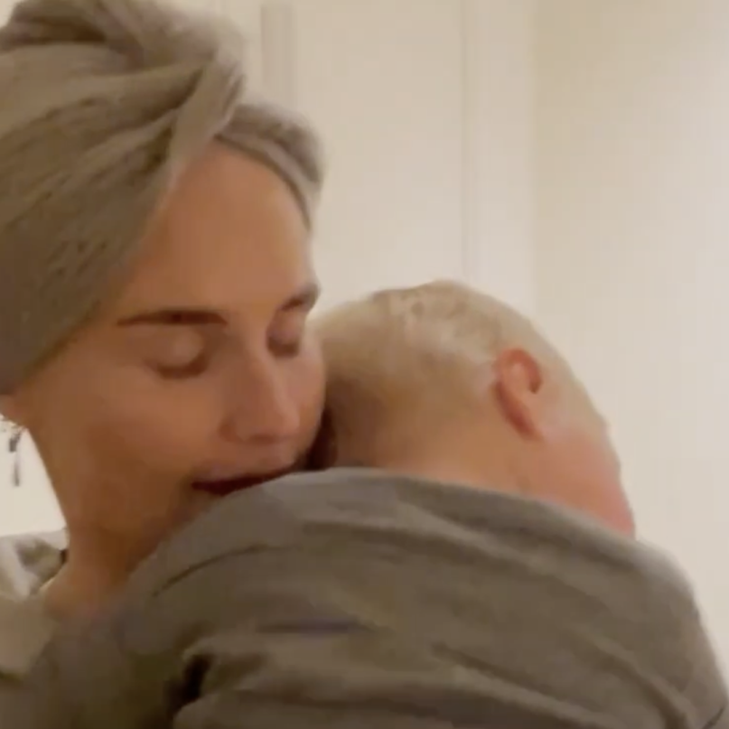 A woman holding a child in an embrace