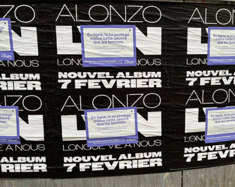 A wall with music posters that have been covered up with an awareness campaign about cyber violence against women.