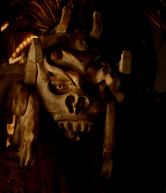 A masked monster stares in the dark