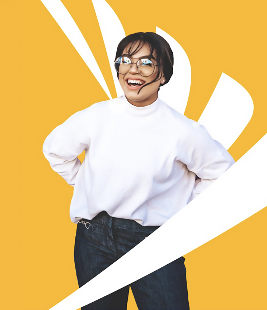 A person smiling and standing in front of a Sprint logo