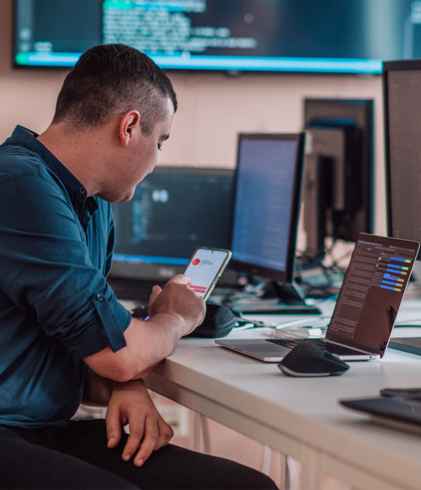 A person working at a desk with a bunch of computer equipment