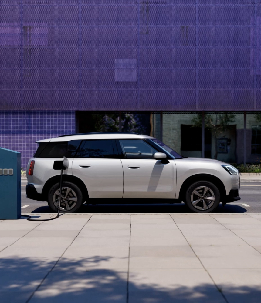 A mini cooper electric charging on the street