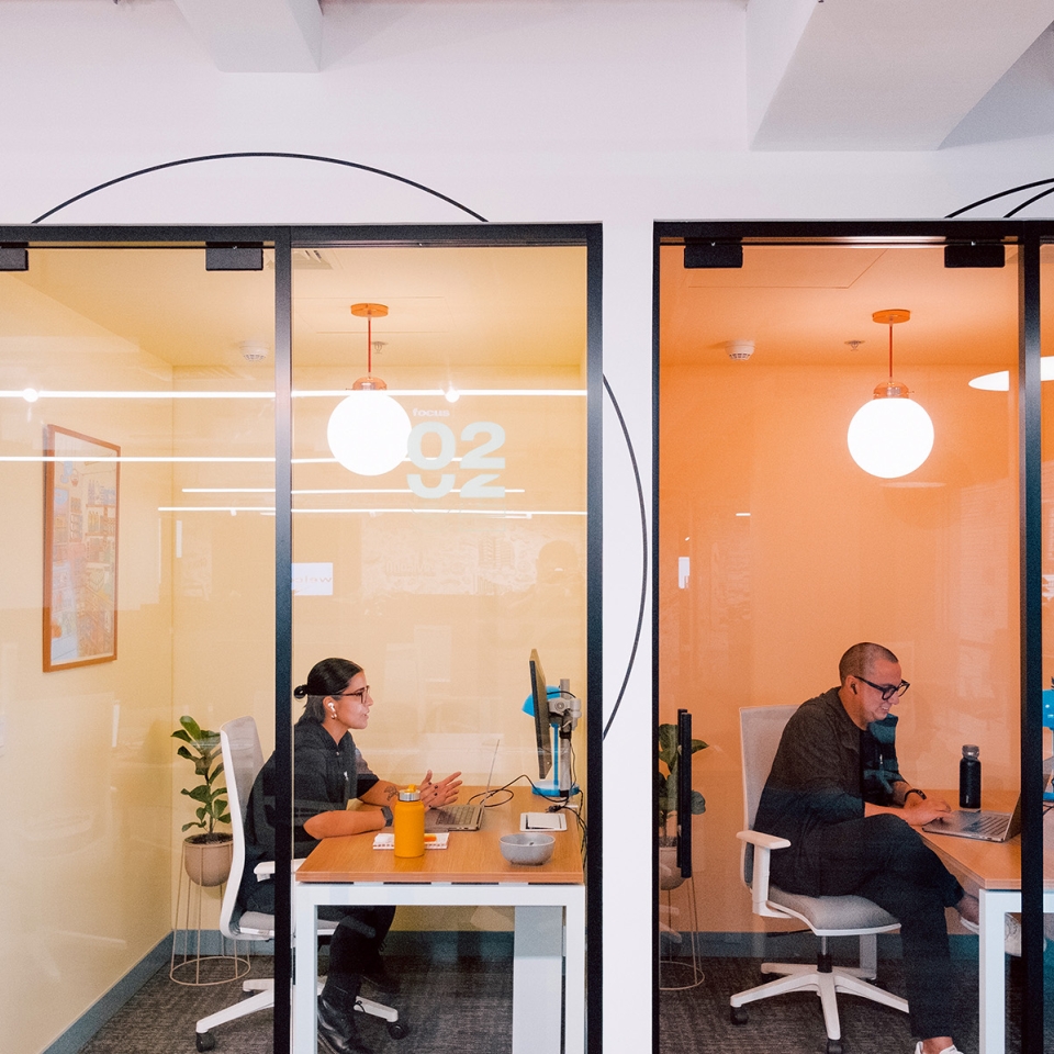 Employees working in small meeting rooms