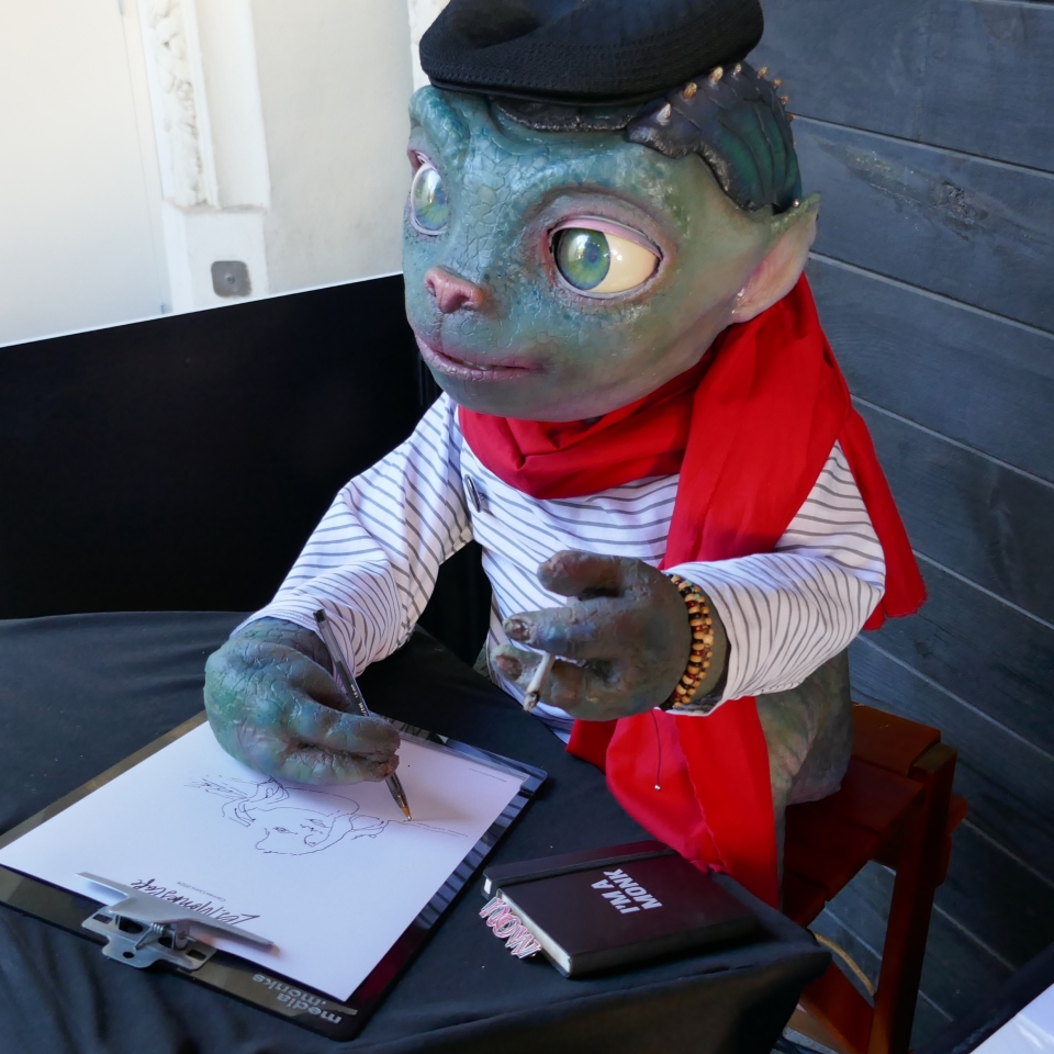 A lizard like robot drawing portraits