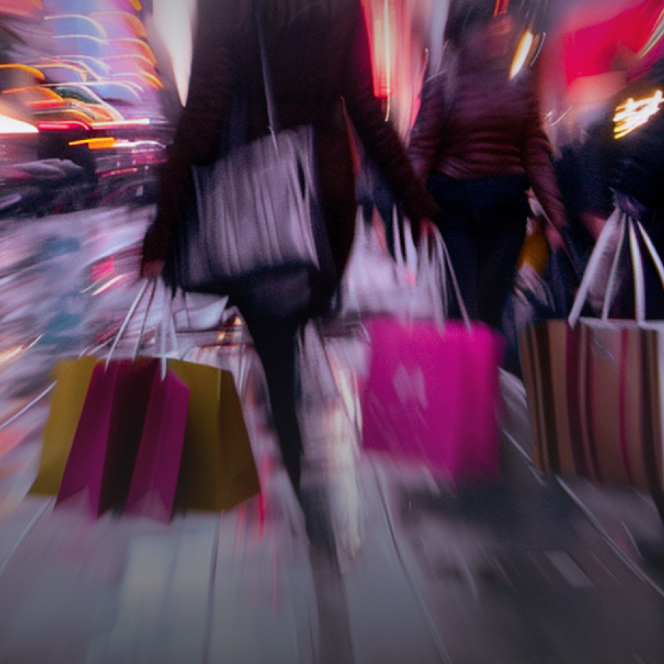 woman watched from the back with shopping bags on the street