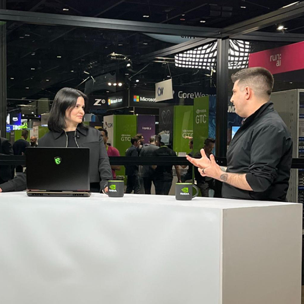 Lewis speaking with someone at a booth during GTC conference