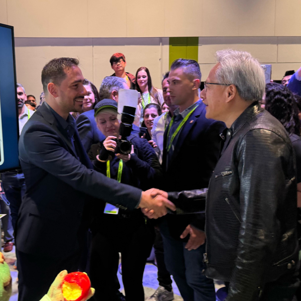 NVIDIA CEO Jensen Huang shaking hands with a presenter at GTC 2025