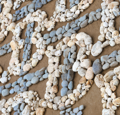 Rocks on a beach making up the Burberry Monogram