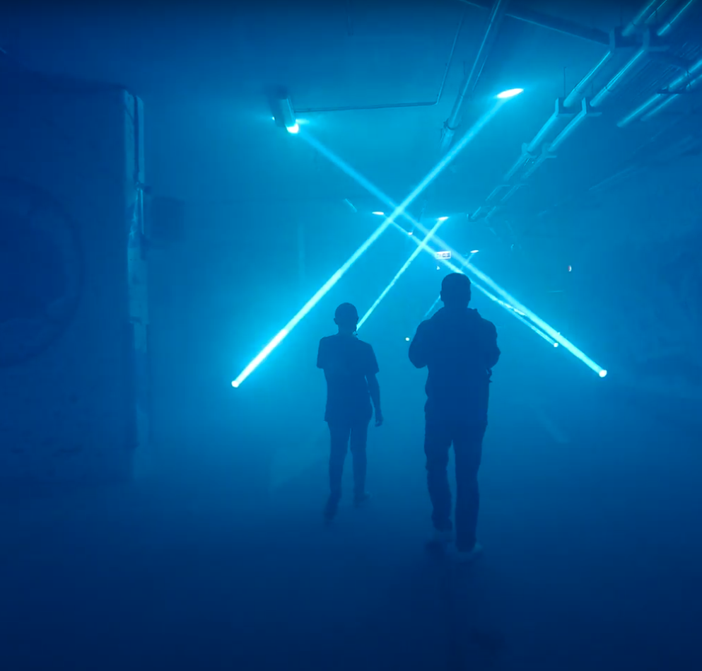 Strobe lights and smoke cover to live players in a dark exhibit room