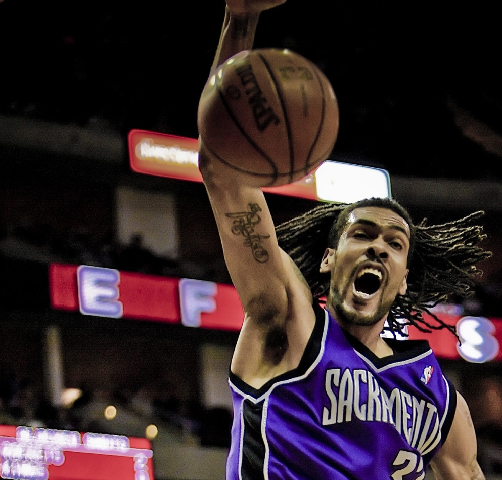 A person slamdunking a basketball
