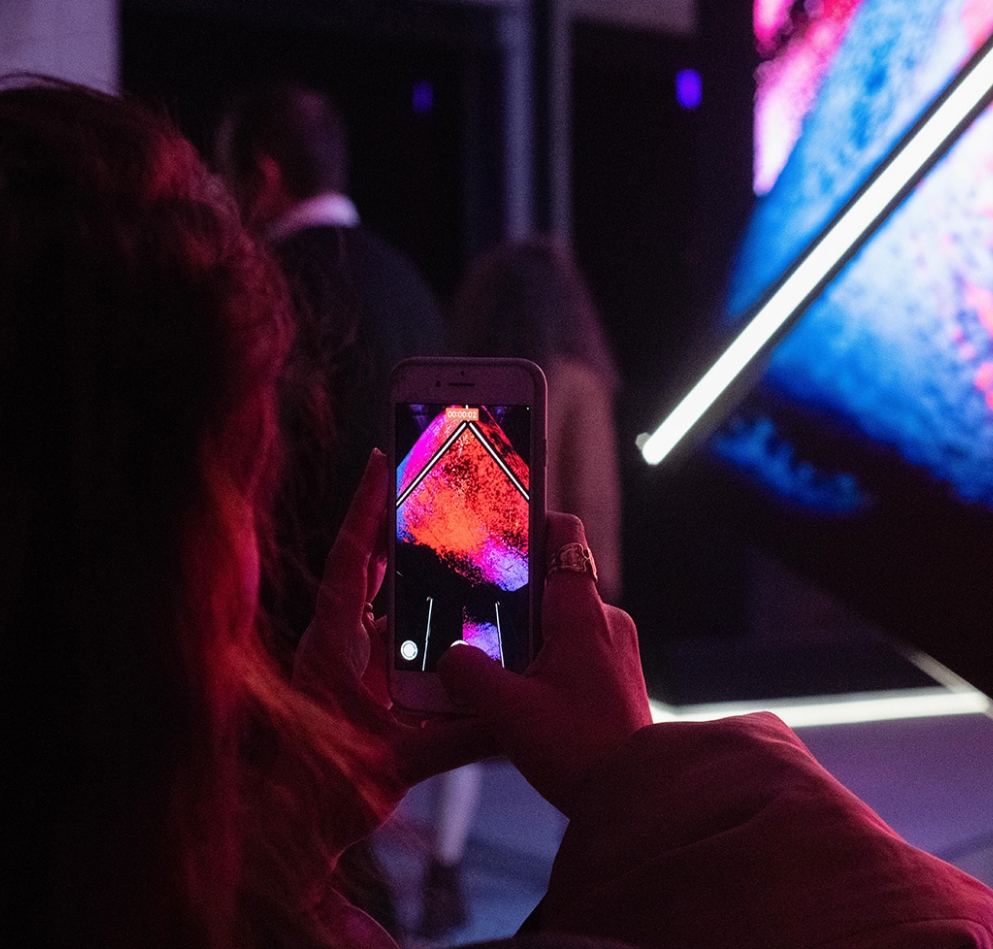 Someone videoing on their cellphone the cube