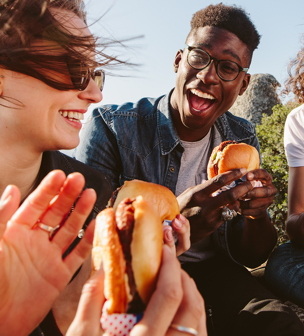 A group of people enjoying hamburgers 