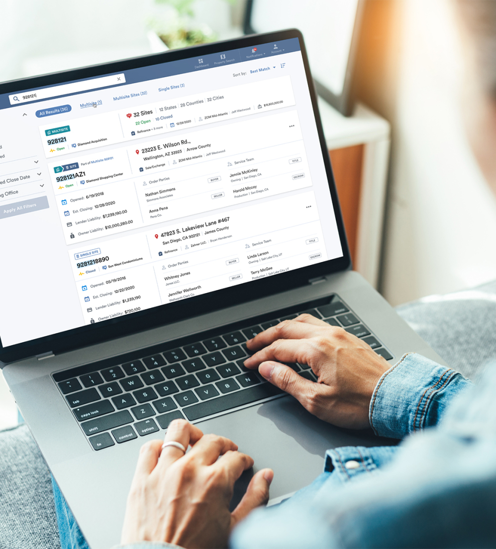 Someone working on a laptop with the First American platform on the screen