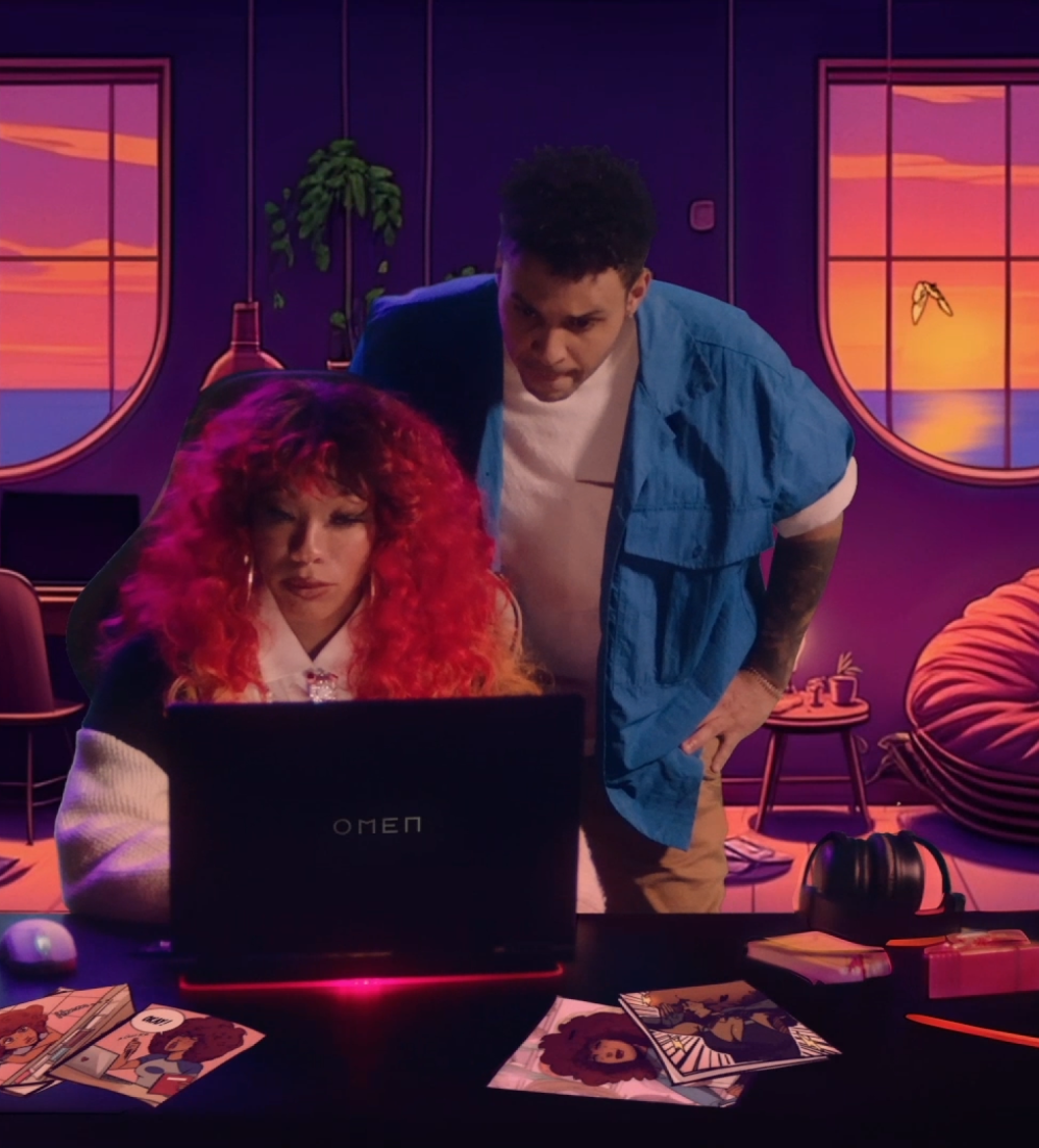 A woman sitting behind a Omen laptop and a man standing behind her looking over her shoulder. The background of the image is illustrated. It shows a living room with a cat on a chair and plants. All in purple and orange tinted colours.