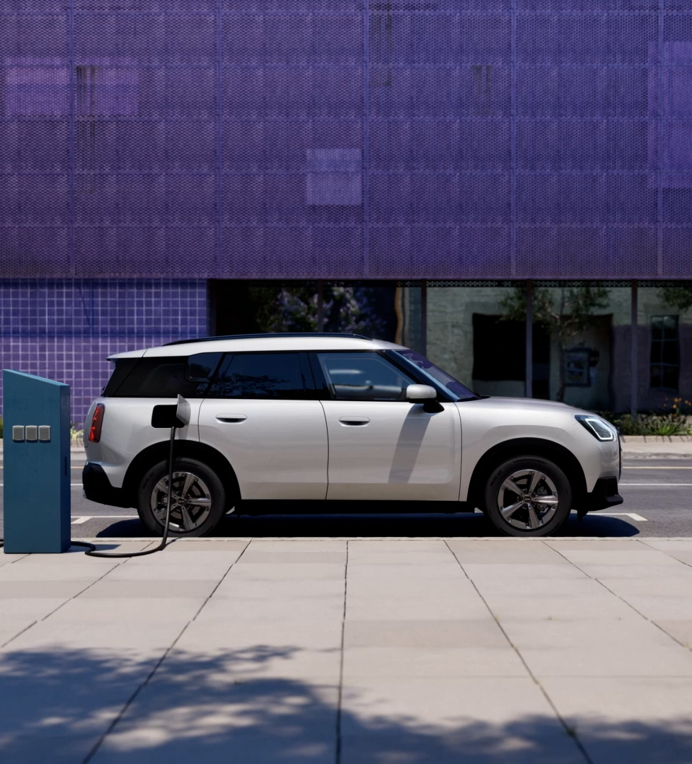 An electric mini countrymen car charging on the street