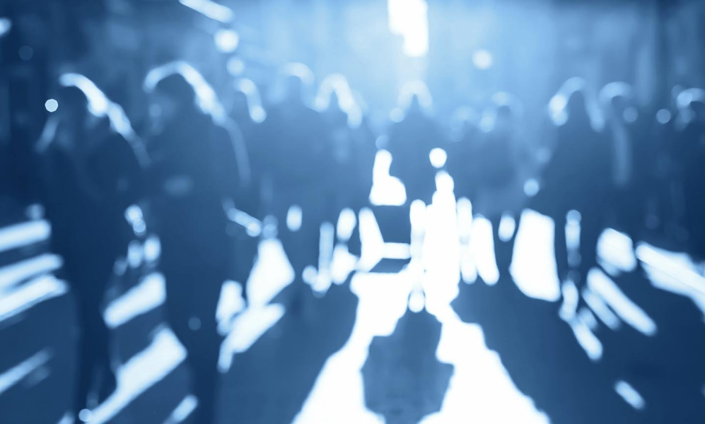 blurry picture of people walking on a street