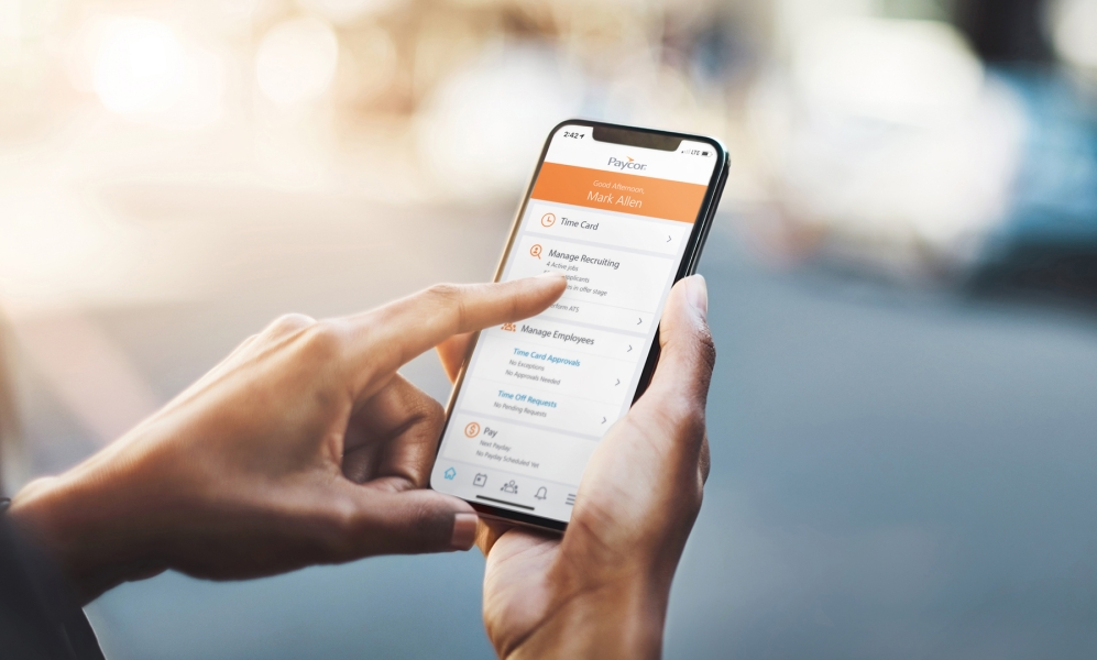 A phone showing Paycor's application interface