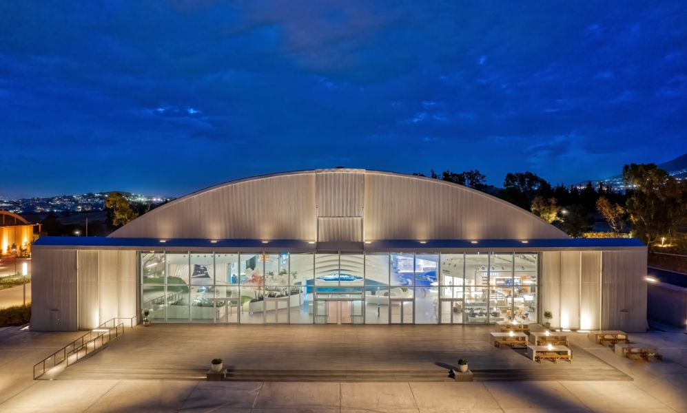 A large airplane hanger all lit up in the night