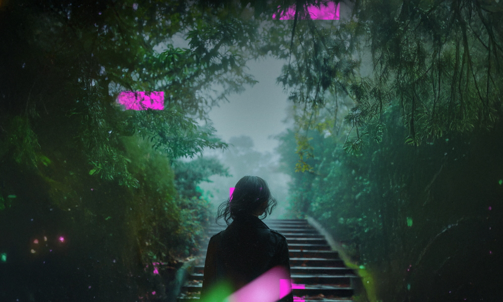 woman walking up stairs to a clearing in a forest