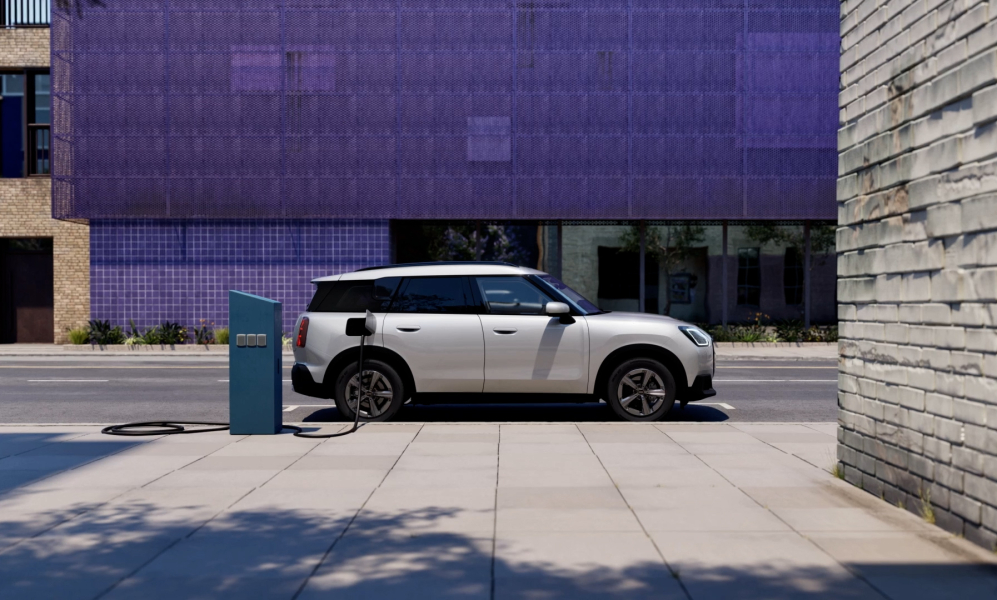 A mini cooper electric charging on the street