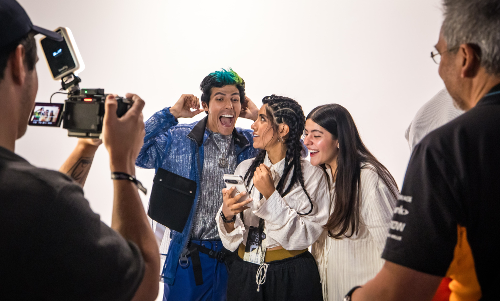 Experiential marketing event attendees are filmed interacting with a Google device, highlighting the creation of multi-modal content (video, social media, case study image) for a brand activation strategy.