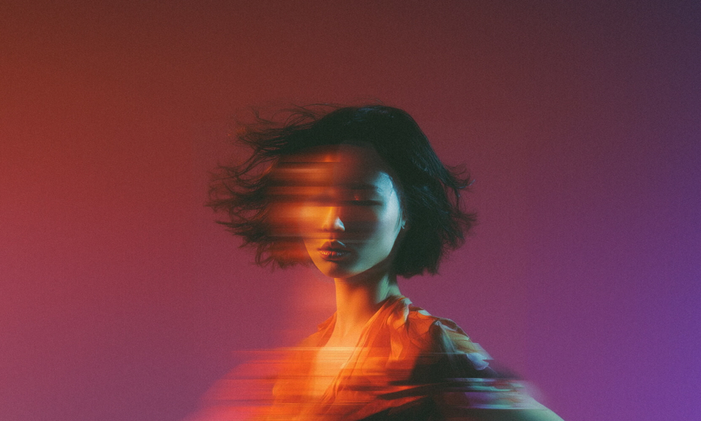 woman with digital effect that makes it look like a long exposure photo where she is moving horizontally