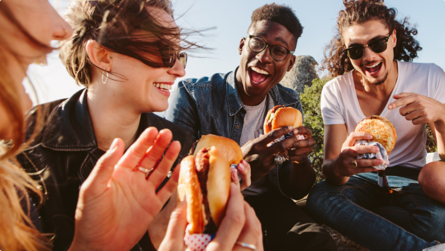 A group of people enjoying hamburgers 