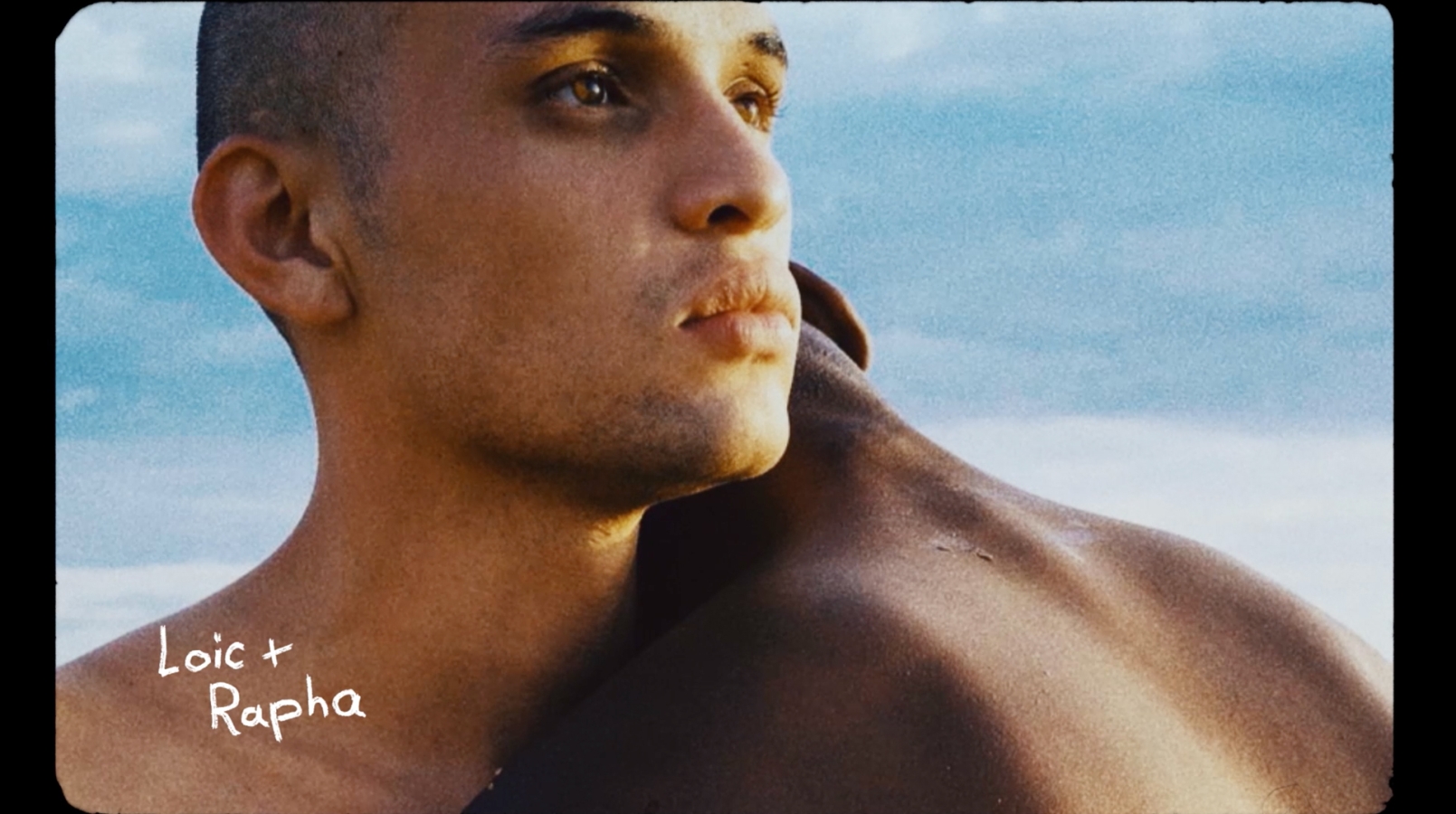 A couple hugging, with text Loic + Rapha