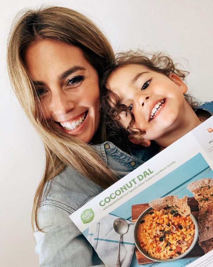 Mother reading Hello Fresh menu with child