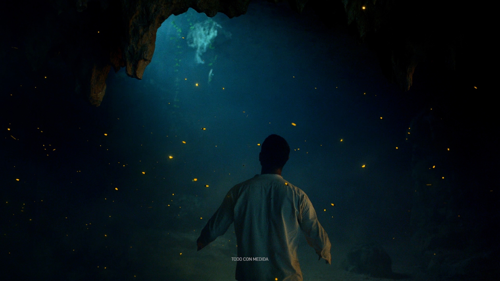 A person stares at the roof of a cave