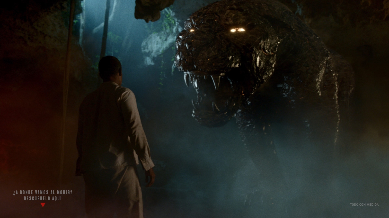 A monster appears from the top of a cave